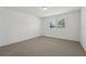 Bright bedroom with neutral carpet and a window at 1337 Oak Valley Dr, Auburndale, FL 33823