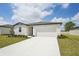 Attractive one-story home with a pristine driveway, a two-car garage, and a well-maintained lawn at 1337 Oak Valley Dr, Auburndale, FL 33823