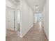 Long hallway features tile floors, doorways to rooms, and recessed lighting at 1337 Oak Valley Dr, Auburndale, FL 33823