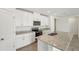 Updated kitchen with granite counters, stainless appliances, and modern cabinets at 1337 Oak Valley Dr, Auburndale, FL 33823