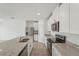 Modern kitchen with stainless steel appliances, white cabinetry, granite countertops, and an island sink at 1337 Oak Valley Dr, Auburndale, FL 33823