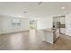 Bright open floor plan features an island with seating, tile flooring, and recessed lighting at 1337 Oak Valley Dr, Auburndale, FL 33823