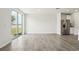 Spacious living area with sliders to the backyard, stainless steel refrigerator, and tile flooring at 1337 Oak Valley Dr, Auburndale, FL 33823