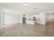 Bright, open-concept living room and kitchen featuring tile floors and white cabinets at 1337 Oak Valley Dr, Auburndale, FL 33823