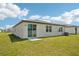 A view of the home's backyard and sliding glass door at 1341 Oak Valley Dr, Auburndale, FL 33823