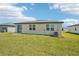 A view of the home's backyard and sliding glass door at 1341 Oak Valley Dr, Auburndale, FL 33823