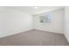 Bright bedroom featuring neutral carpet and a window at 1341 Oak Valley Dr, Auburndale, FL 33823