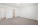 Bright bedroom featuring neutral carpet and bathroom doorway at 1341 Oak Valley Dr, Auburndale, FL 33823
