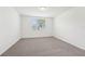 Comfortable bedroom features neutral carpet, paint, and a window at 1341 Oak Valley Dr, Auburndale, FL 33823