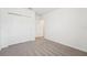 Bedroom featuring neutral carpet, closet, and entry to another room at 1341 Oak Valley Dr, Auburndale, FL 33823