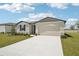 Charming single-story home featuring a two-car garage and well-maintained front yard at 1341 Oak Valley Dr, Auburndale, FL 33823