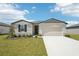 Charming single-story home featuring a two-car garage and well-maintained front yard at 1341 Oak Valley Dr, Auburndale, FL 33823