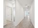 Hallway with neutral paint, recessed lighting and tile floor at 1341 Oak Valley Dr, Auburndale, FL 33823