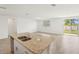 Modern open concept kitchen featuring a large island, stainless steel appliances, and tile flooring at 1341 Oak Valley Dr, Auburndale, FL 33823