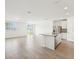 Open concept living space with tile floors, island and stainless steel appliances at 1341 Oak Valley Dr, Auburndale, FL 33823