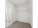 Bright walk-in closet features neutral carpet and wire shelving at 1341 Oak Valley Dr, Auburndale, FL 33823