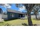 Backyard featuring a well-maintained lawn, a wooden deck, a privacy fence, and mature trees at 1727 Saffron Plum Ln, Orlando, FL 32828
