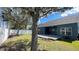 Well-maintained backyard with grass, deck, privacy fence and trees at 1727 Saffron Plum Ln, Orlando, FL 32828