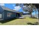 A well-maintained backyard with a wooden deck, privacy fence, grass and shrubbery at 1727 Saffron Plum Ln, Orlando, FL 32828