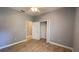 Empty bedroom with closet and door, neutral paint, and tile flooring at 1727 Saffron Plum Ln, Orlando, FL 32828