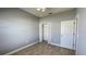 Bedroom with neutral walls and tile flooring, featuring a closet and door at 1727 Saffron Plum Ln, Orlando, FL 32828