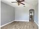 Bedroom with tile floors, neutral paint and archway into hallway at 1727 Saffron Plum Ln, Orlando, FL 32828