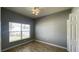Comfortable bedroom featuring a window, tile flooring and a ceiling fan at 1727 Saffron Plum Ln, Orlando, FL 32828