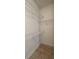 Bright walk-in closet featuring shelving and tile flooring at 1727 Saffron Plum Ln, Orlando, FL 32828