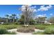 Community clubhouse with beautiful landscaping including trees and flowers at 1727 Saffron Plum Ln, Orlando, FL 32828