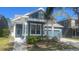 Charming home exterior featuring a well-manicured front yard and a covered front porch at 1727 Saffron Plum Ln, Orlando, FL 32828