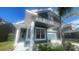 Charming two-story home with blue siding, white columns, manicured landscaping, and a two car garage at 1727 Saffron Plum Ln, Orlando, FL 32828