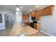 Kitchen with stainless steel appliances, tile flooring, breakfast bar and wooden cabinets at 1727 Saffron Plum Ln, Orlando, FL 32828