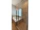 Shower and tub combination featuring tile surround, glass door and an accent window at 1727 Saffron Plum Ln, Orlando, FL 32828