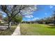 Beautiful street view with large grassy field and mature trees at 1727 Saffron Plum Ln, Orlando, FL 32828