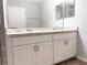 Bathroom featuring a double vanity with granite countertop and a tiled shower at 2906 Fieldwood Cir, St Cloud, FL 34772
