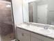 Bathroom featuring a double vanity, granite countertop, and tiled shower at 2906 Fieldwood Cir, St Cloud, FL 34772