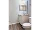 Bathroom with light wood-look floors, white vanity, and toilet at 2906 Fieldwood Cir, St Cloud, FL 34772