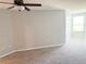 Bedroom featuring carpet, ceiling fan, and a bright window at 2906 Fieldwood Cir, St Cloud, FL 34772