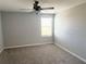 Neutral bedroom featuring gray walls, carpet flooring, and a ceiling fan at 2906 Fieldwood Cir, St Cloud, FL 34772