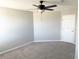 Bedroom showcasing neutral walls and carpet, featuring a ceiling fan and closet at 2906 Fieldwood Cir, St Cloud, FL 34772