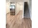 Hallway with stairs, a stainless steel refrigerator, and wood-look flooring at 2906 Fieldwood Cir, St Cloud, FL 34772