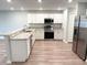 Well-lit kitchen with white cabinets, granite countertops, and stainless steel appliances at 2906 Fieldwood Cir, St Cloud, FL 34772