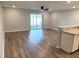 Bright, open-concept living area with wood-look floors and a sliding glass door to the backyard at 2906 Fieldwood Cir, St Cloud, FL 34772