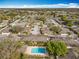 Overhead view of a community with a pool, tennis courts, landscaping, parking, and numerous homes at 542 Cascade Cir # 102, Casselberry, FL 32707