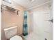 Bathroom featuring a walk-in shower with blue patterned shower curtain, and a toilet with hand towel rack at 542 Cascade Cir # 102, Casselberry, FL 32707