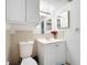 Cozy bathroom featuring a vanity with sink, mirror, and a tiled backsplash plus a toilet and storage at 542 Cascade Cir # 102, Casselberry, FL 32707