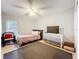 Neutral bedroom featuring a tile floor, ceiling fan, and a dresser topped with a television at 542 Cascade Cir # 102, Casselberry, FL 32707