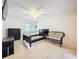 Bright bedroom with tile flooring, ceiling fan, and a wicker sofa next to a bed frame at 542 Cascade Cir # 102, Casselberry, FL 32707