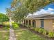 A home's exterior is adorned with arched entrances and manicured greenery, enhancing its street appeal at 542 Cascade Cir # 102, Casselberry, FL 32707