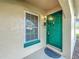 The property features a vibrant green front door, creating a welcoming entrance to this home at 542 Cascade Cir # 102, Casselberry, FL 32707